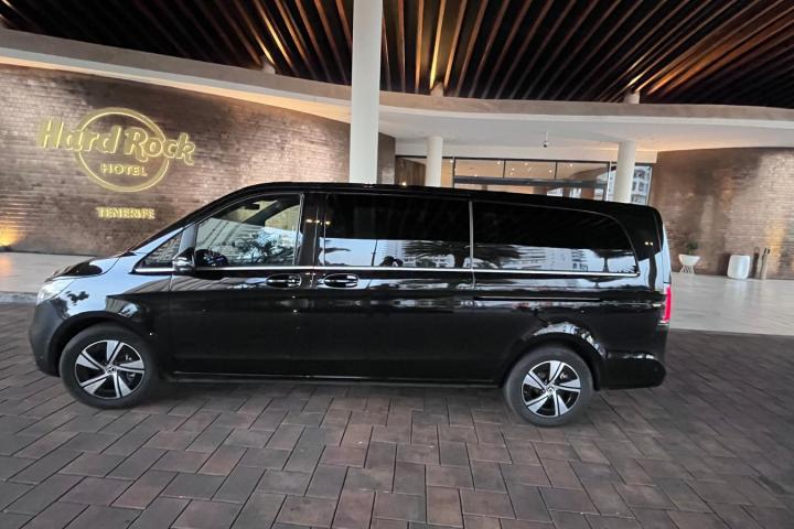Black van parked in front of Hard Rock Hotel Tenerife entrance.