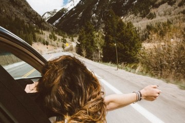 a person sitting on the side of the road