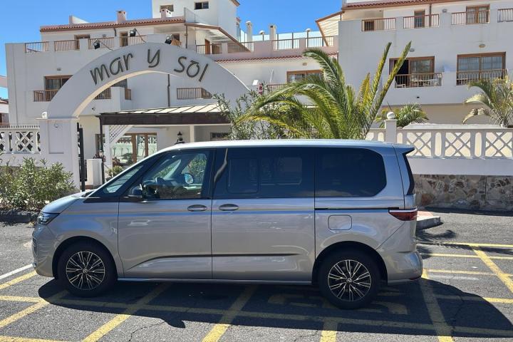 Silver van parked in front of a hotel entrance with 'Mar y Sol' sign.