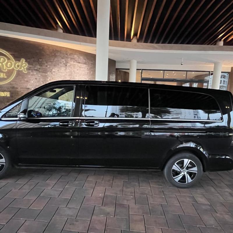 Black van parked outside Hard Rock Hotel entrance.