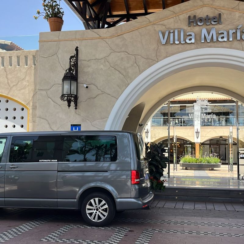 Grey van parked in front of Hotel Villa Maria entrance.