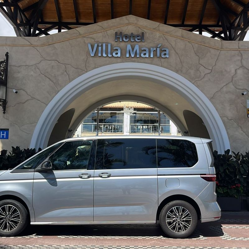 Van parked in front of Hotel Villa Maria entrance.